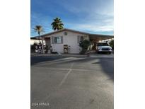 Single-story home with a carport and holiday decorations at 11596 W Sierra Dawn Blvd # 156, Surprise, AZ 85378