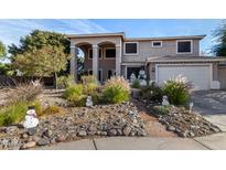 Two-story house with landscaped front yard and a three-car garage at 20171 N Bustos Way, Maricopa, AZ 85138