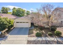 Charming single-story home with a two-car garage and desert landscaping at 2957 E Melrose St, Gilbert, AZ 85297