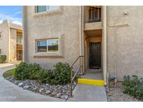 Front entrance of a two-story condo with desert landscaping and a paved walkway at 7436 E Chaparral Rd # 159B, Scottsdale, AZ 85250