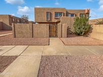 Front yard of a two-story home with a gated entrance and desert landscaping at 1433 N 53Rd Ave, Phoenix, AZ 85043