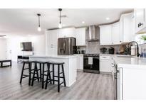 Stylish kitchen with white cabinetry, stainless steel appliances, and an island with bar stools at 2041 E Harvard Dr, Tempe, AZ 85283
