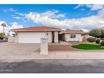 Charming single-story home with a tile roof, attached two-car garage, and manicured landscaping at 26201 S Sherbrook Dr, Sun Lakes, AZ 85248