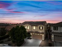 Two-story home with solar panels, a two-car garage, and a landscaped front yard at dusk at 2872 E Redwood Pl, Chandler, AZ 85286