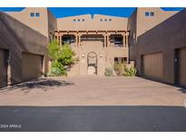 Inviting Southwestern style townhome with attached garages and paver driveway at 36601 N Mule Train Rd # B14, Carefree, AZ 85377