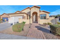 Inviting single-story home with a paved walkway, landscaped front yard, and attached two-car garage at 43202 W Delia Blvd, Maricopa, AZ 85138