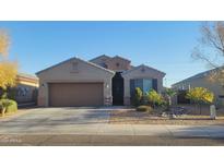 Charming one-story home with a two-car garage and landscaped front yard at 23793 W Ripple Rd, Buckeye, AZ 85326