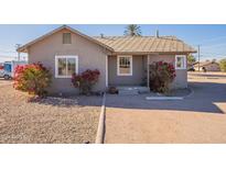 Charming single-story home with a gravel yard and vibrant bougainvillea at 711 N Walnut Ave, Casa Grande, AZ 85122