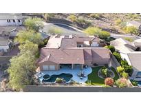 An aerial view of a home with a terracotta tiled roof, a backyard swimming pool, a lush grassy yard, and desert landscaping at 3512 W Hidden Mountain Ct, Phoenix, AZ 85086