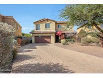 Inviting two-story home with a paver driveway and desert landscaping at 8214 S 15Th St, Phoenix, AZ 85042