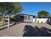 Charming bungalow with gray exterior, red door, and a deck at 1410 E Earll Dr, Phoenix, AZ 85014