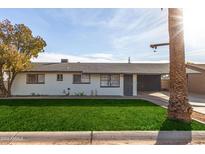 Ranch style home with carport and nicely landscaped front yard at 3921 W Griswold Rd, Phoenix, AZ 85051