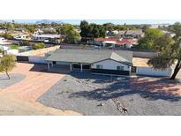 Aerial view of a remodeled mid-century modern home with a landscaped front yard at 6528 E Bambi Dr, Mesa, AZ 85215