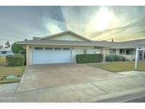 Ranch style home with attached garage and well-manicured lawn at 10225 N 105Th Dr, Sun City, AZ 85351
