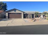 Single-story home with desert landscaping and a two-car garage at 1411 Leisure World --, Mesa, AZ 85206