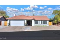 Single-story home with a tile roof, two-car garage, and landscaped front yard at 2224 W Highland St, Chandler, AZ 85224