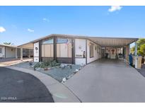 Manufactured home with covered porch and American flag at 661 S Hawes Rd # 5, Mesa, AZ 85208