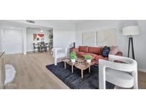 Comfortable living room featuring an orange couch, two white armchairs and wood coffee table at 4141 N 31St St # 414, Phoenix, AZ 85016