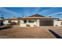 White single story home with black garage door and landscaping at 7606 N 45Th Dr, Glendale, AZ 85301