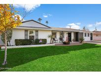 Beautiful ranch home with a well-manicured lawn and firepit at 4015 E Catalina Dr, Phoenix, AZ 85018