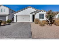 Single-story home with white exterior, two-car garage, and paved driveway at 630 E Bamboo Ln, San Tan Valley, AZ 85140