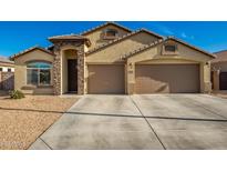 Two-story house with a three-car garage and desert landscaping at 21836 W Hopi St, Buckeye, AZ 85326