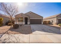 One-story house with a brown garage door and desert landscaping at 1241 E Paul Dr, Casa Grande, AZ 85122