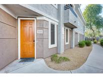 Inviting exterior with a wood door and well-maintained landscaping at 15221 N Clubgate Dr # 2098, Scottsdale, AZ 85254