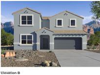 Two-story house with gray exterior, three windows on the second floor and two on the first floor, a two-car garage, and a small front yard at 2112 W Stanton Ave, Apache Junction, AZ 85120