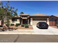 One-story house with tile roof, two-car garage, and desert landscaping at 8816 W Palmaire Ave, Glendale, AZ 85305