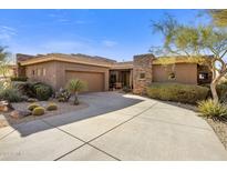 Single-story home with stone accents and desert landscaping at 10821 E Tusayan Trl, Scottsdale, AZ 85255