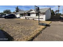 Ranch style home with basketball hoop and dry front yard at 2208 N 82Nd St, Scottsdale, AZ 85257