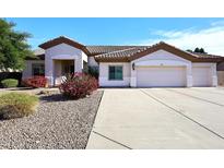 Single-story home with a three-car garage and desert landscaping at 23307 N 71St Dr, Glendale, AZ 85310