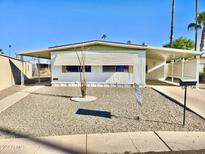 Single-wide manufactured home with carport and gravel landscaping at 2601 E Allred Ave # 20, Mesa, AZ 85204