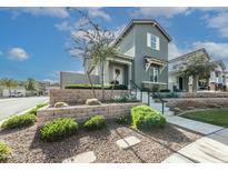 Two-story craftsman style home with stone accents and landscaped yard at 21065 W Elm Way Ct, Buckeye, AZ 85396