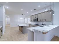 Modern kitchen with marble countertops and stainless steel appliances at 1270 E Baranca Rd, Gilbert, AZ 85297