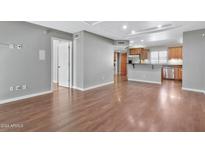 Living room with hardwood floors, kitchen view, and open floor plan at 16616 E Palisades Blvd # 102, Fountain Hills, AZ 85268