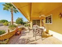 Covered patio with seating area, tile flooring, and desert landscaping at 17806 N 130Th Ave, Sun City West, AZ 85375