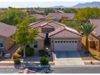 Single-story home with tile roof, two-car garage, and desert landscaping; mountain views at 2627 E San Simeon Dr, Casa Grande, AZ 85194