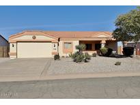 One-story home with light-colored exterior, two-car garage, and desert landscaping at 11100 W Magdalena Dr, Arizona City, AZ 85123
