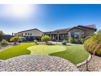 Landscaped backyard with putting green and patio at 16731 S 181St Ave, Goodyear, AZ 85338