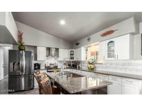 Modern kitchen features granite countertops and stainless steel appliances at 20165 W Moccasin Trl, Buckeye, AZ 85326