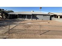 Gray single story house with a chain link fence and small front yard at 420 N 29Th St, Phoenix, AZ 85008