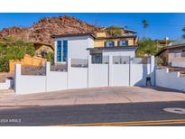 Modern two-story home with a white exterior and mountain views at 8451 N 14Th St, Phoenix, AZ 85020