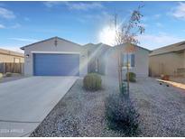 Single-story home with blue garage door and landscaped front yard at 2607 E Corazon Trl, Casa Grande, AZ 85194
