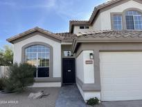 Front view of two-story house with a decorative door and walkway at 6891 W Via Del Sol Dr, Glendale, AZ 85310