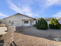 Ranch style home with a well-maintained front yard and a two-car garage at 724 N 66Th Pl, Mesa, AZ 85205