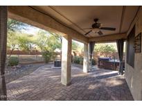 Relaxing backyard patio with a hot tub and fire pit at 26053 W Tonopah Dr, Buckeye, AZ 85396