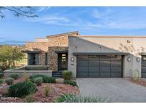 Modern home with stone accents and a two-car garage at 16064 E Ridgestone Dr, Fountain Hills, AZ 85268