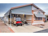 Inviting exterior of manufactured home with carport and golf cart at 17200 W Bell Rd # 1740, Surprise, AZ 85374